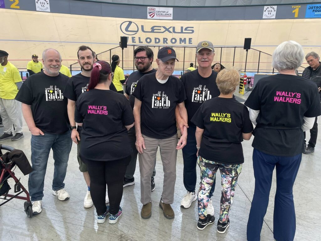 A group of walkers with shirts saying "Wally's Walkers" and "Walk by Faith, Not by Sight" at the GDABIV 5K Walk.